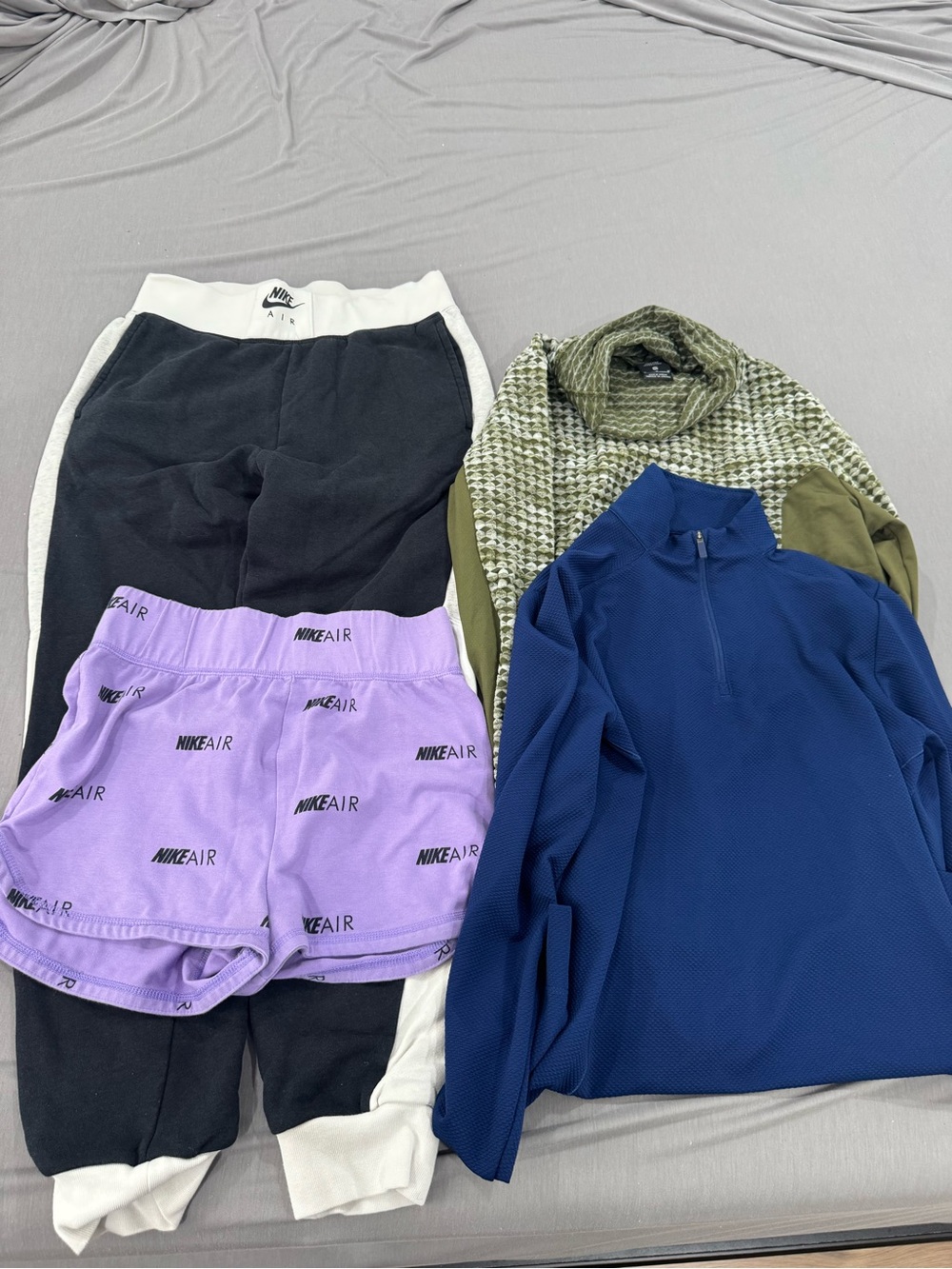 Woman Nike black and white joggers with lavender Nike Air shorts and two sweater